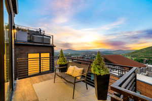 Balcony at dusk featuring a mountain view