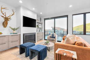 Living room with light hardwood / wood-style floors