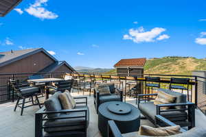 View of patio featuring an outdoor living space and a mountain view