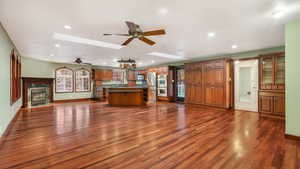 Kitchen with a kitchen island, dark wood-type flooring, appliances with stainless steel finishes, and a skylight