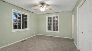 Unfurnished room featuring ceiling fan and light colored carpet