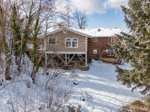 View of snow covered rear of property