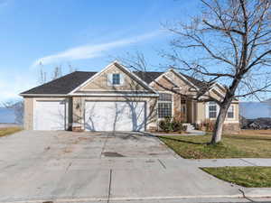 View of front of house with a garage and a front lawn