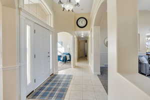 Entrance foyer featuring a towering ceiling and an inviting chandelier