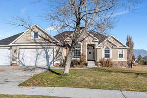 Front facade with a front lawn and a garage