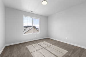 Unfurnished room with carpet floors