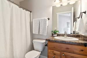 Bathroom featuring vanity and toilet