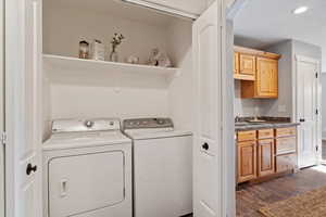 Washroom featuring independent washer and dryer, dark wood-type flooring, and sink