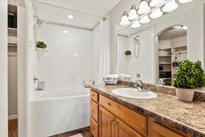 Bathroom featuring vanity and shower / bath combo with shower curtain