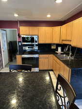 Kitchen with backsplash, stainless steel appliances, and sink