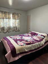 Bedroom featuring dark hardwood / wood-style floors