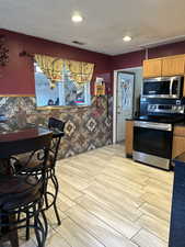 Kitchen with light wood-type flooring and stainless steel appliances