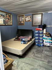 Bedroom featuring wood walls