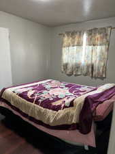 Bedroom with wood-type flooring