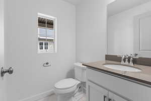 Bathroom with tile patterned flooring, vanity, and toilet