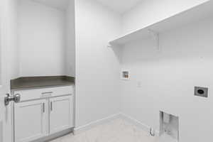 Laundry room with cabinets, washer hookup, and hookup for an electric dryer