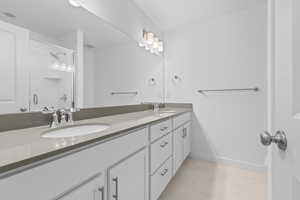 Bathroom with vanity and a shower with shower door