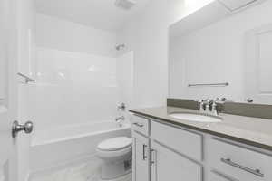 Full bathroom featuring vanity, shower / bathing tub combination, and toilet