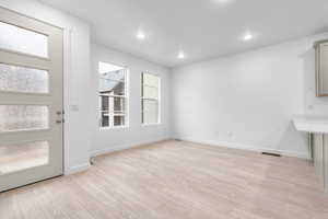 Unfurnished dining area featuring light hardwood / wood-style floors