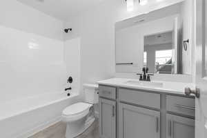 Full bathroom featuring vanity, shower / bathing tub combination, wood-type flooring, and toilet