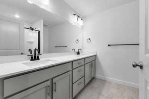 Bathroom featuring vanity and a shower with shower door