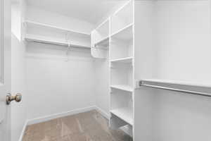 Walk in closet featuring light carpet