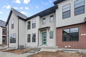 View of front of property featuring central AC unit