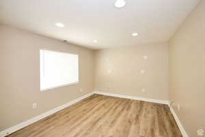 Unfurnished room with light hardwood / wood-style floors