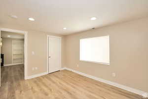 Unfurnished bedroom featuring hardwood / wood-style floors and a closet