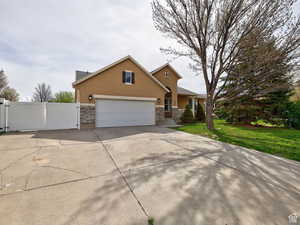 View of front facade featuring a front lawn and a garage