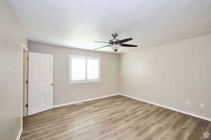 Unfurnished room with ceiling fan, light hardwood / wood-style floors, and a textured ceiling