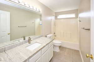 Full bathroom featuring tile patterned flooring, vanity, toilet, and shower / washtub combination