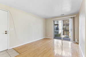 Spare room featuring light hardwood / wood-style floors and ornamental molding