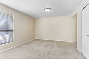 Carpeted spare room with a textured ceiling