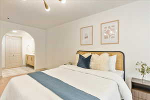 Bedroom featuring light wood-type flooring and connected bathroom