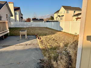 View of yard featuring a mountain view and a patio