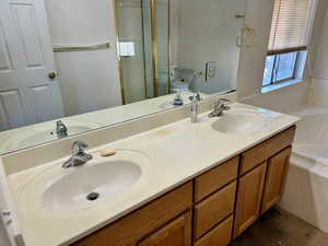 Full bathroom with plus walk in shower, vanity, and toilet