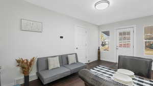 Living room with dark hardwood / wood-style flooring