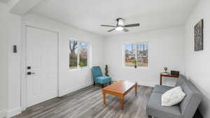 Sitting room featuring hardwood / wood-style flooring and ceiling fan