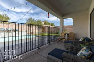 View of patio with a fenced in pool