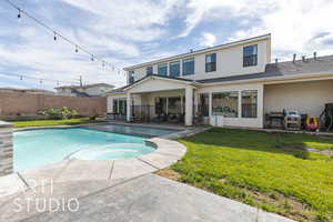 View of swimming pool with a lawn, a patio area, and an in ground hot tub