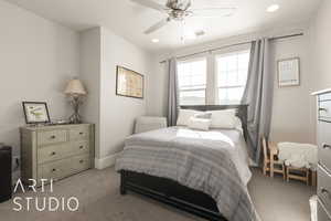 Carpeted bedroom with ceiling fan