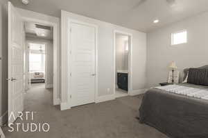 Bedroom featuring carpet, ensuite bathroom, and ceiling fan