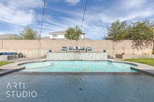 View of swimming pool featuring a hot tub and a patio area