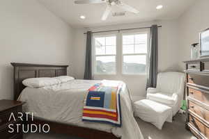 Bedroom featuring vaulted ceiling, dark carpet, and ceiling fan