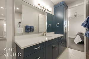 Bathroom featuring tile patterned floors, ceiling fan, and vanity