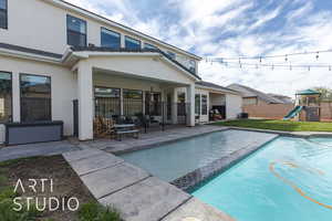 View of pool with a lawn, central AC unit, a playground, and a patio