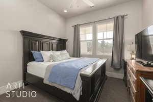 Bedroom featuring dark colored carpet and ceiling fan