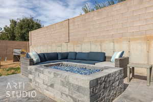 View of patio featuring an outdoor living space with a fire pit