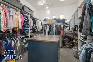 Walk in closet with dark colored carpet